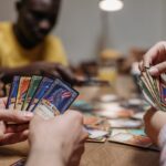 Adults playing a strategy card game together, showcasing teamwork and fun indoors.